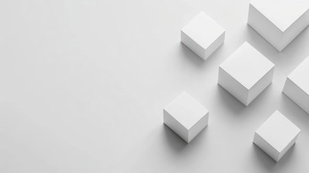 A collection of variously sized white cubes positioned artistically on a light surface.の素材