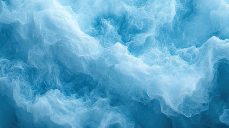 Soft waves roll gently creating white foam as they meet the sandy beach under bright sunlight.の素材