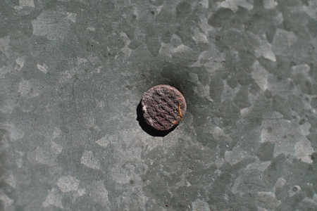 Old iron galvanized roof and rusty nail.の写真素材
