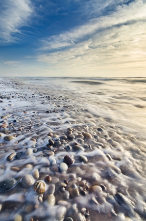 Beautiful beach scene full of pebbles in the coastlineの写真素材