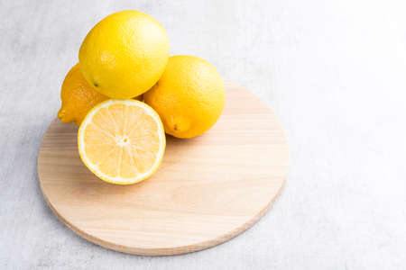 Fresh sicilian lemon slice on a white wooden background.の写真素材