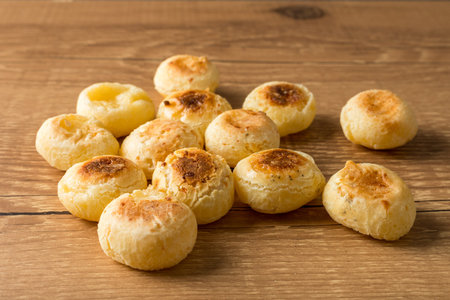 Traditional Brazilian Snack Cheese Bread. On a wooden table background.