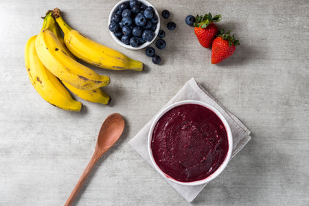Brazilian frozen aÃ§ai berry ice cream bowl. with fruits on wooden background. Summer menu top view. close up.の写真素材