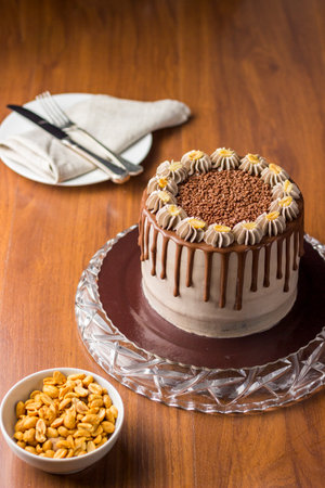 Chocolate and peanut cake. charge cake. On wooden background.の写真素材