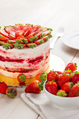 Red velvet cake on white wooden background. with strawberries.の写真素材