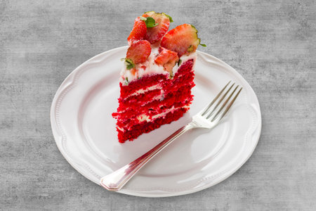 Isolated Red velvet cake on gray wooden background. with strawberries.の写真素材