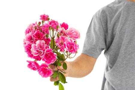 man with flowers on his hands from valentines day gift to girlfriend.の写真素材