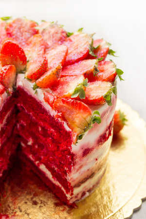 Red velvet cake on white wooden background. with strawberries.の写真素材