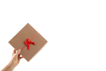 Gift box from valentines day on a man's hand on white background.