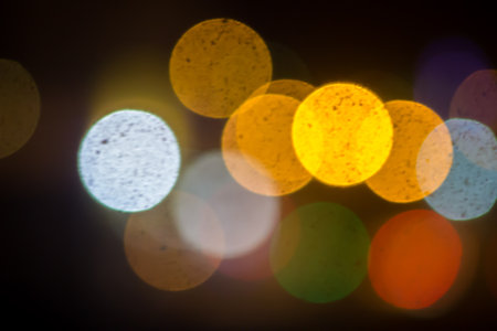 An beautiful Christmas background dark made of blurred colorful lights. Copy space.の写真素材