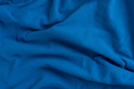 Crumpled linen cloth texture. Wrinkled textile. Blue.