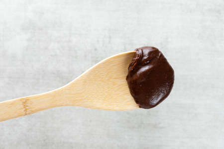 Brazilian vegan Brigadeiro chocolate on a wooden spoonの写真素材