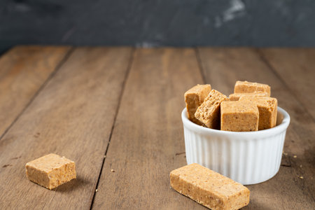 Pacoca is a Brazilian Peanut Sweet. on a white bowl on a wooden deks.の写真素材