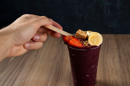 Hand holding Brazilian AÃ§ai Berry with Strawberry, Banana and PaÃ§oca.の写真素材
