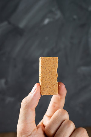 Fingers holding a Brazilian Peanut Sweet called PaÃ§oca.の写真素材