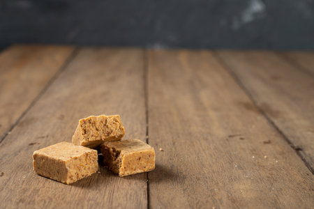 Stack of Brazilian Peanut Sweet called paÃ§oca on a wooden desk.の写真素材
