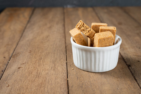 Pacoca is a Brazilian Peanut Sweet. on a white bowl on a wooden deks.の写真素材