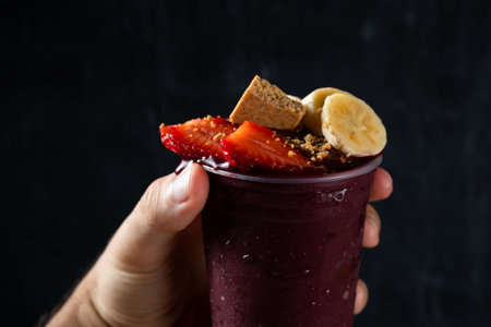 Hand holding Brazilian AÃ§ai Berry with Strawberry, Banana and PaÃ§oca.の写真素材