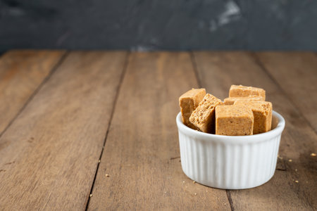 Pacoca is a Brazilian Peanut Sweet. on a white bowl on a wooden deks.の写真素材