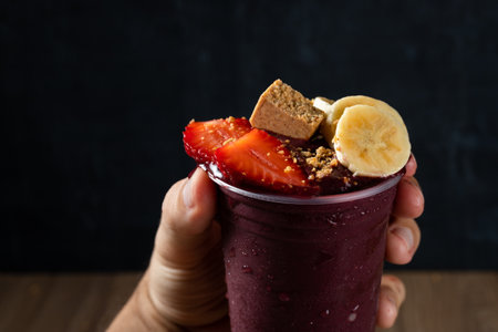 Hand holding Brazilian AÃ§ai Berry with Strawberry, Banana and PaÃ§oca.の写真素材