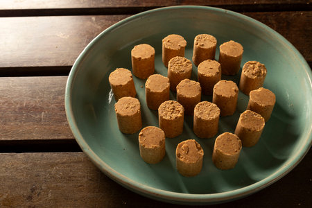 Sweet Brazilian Peanut Called PaÃ§oca on a blue plate.