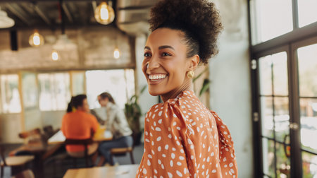 Smiling african american woman looking at camera in coffee shopの素材