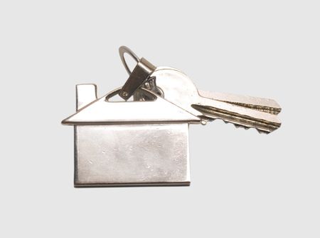 Keys to the house with a metal thumb image buildingの写真素材