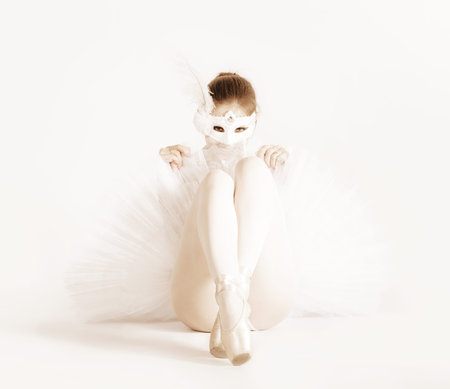 Ballerina in a white skirt and a bathing suit, pointe, dance posesの写真素材