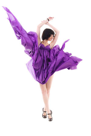graceful girl in flying purple silk dress on a white backgroundの写真素材