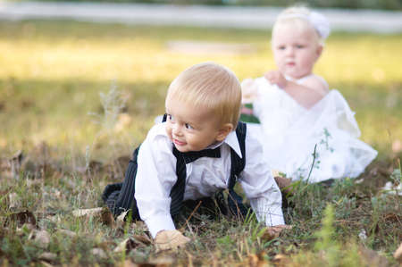 Children dressed as bride and groom play with each otherの写真素材