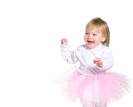 Happy laughing young girl in a pink ballet skirt playing and smilesの写真素材