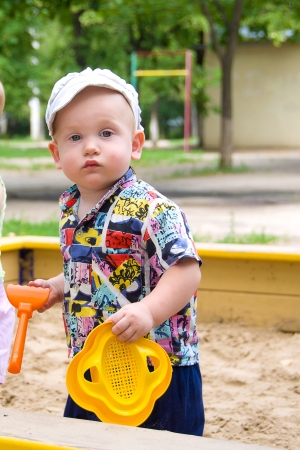 little boy playing outside in the summer childrenの写真素材