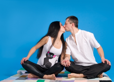 pregnant parents-in anticipation of child, on blue background in studioの写真素材