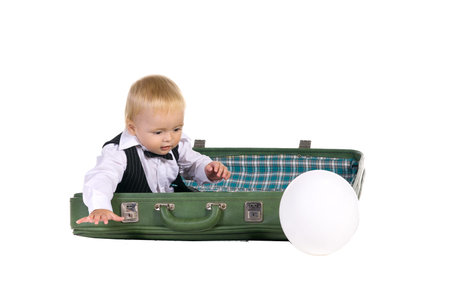 boy going on a trip, with suitcases, isolated on white backgroundの写真素材