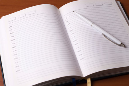 White pen on diary. Working day schedule