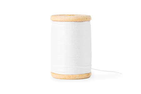wooden spool with white thread close up on white background.の写真素材
