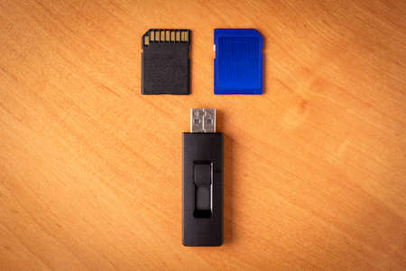 Flash drive. Memory card.Wood background.Memory drives on the tableの写真素材