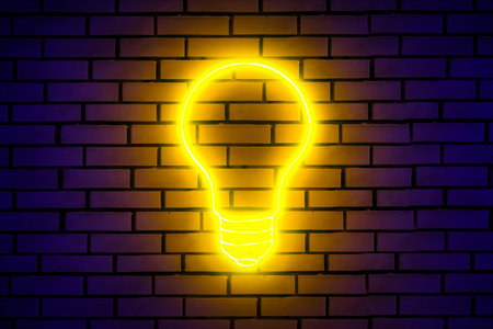 Neon light bulb sign on brick wall