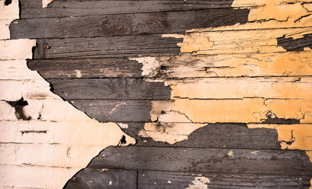 The old wooden wall made %u200B%u200Bof planks with peeling beige paintの写真素材