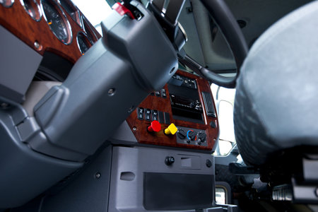 Modern ergonomic and stylish dashboard of heavy semi truck with lots of equipment, Steering column,...