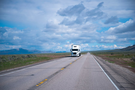 Popular model of white semi truck with a comfortable interior cabin for the professional long haul...