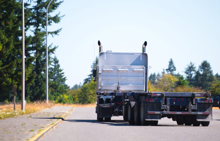 Professional American big rig high cab powerful white semi truck with vertical exhaust pipes and...