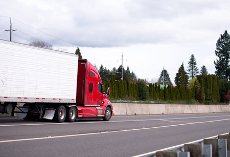 Big rig modern red semi truck tractor with refrigerator semi trailer for timely delivery of...
