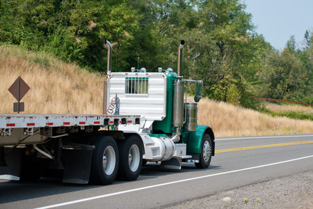 Professional big rig day cab semi trucks with flat trailers are popular for local transportations...