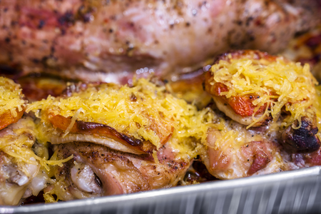 Appetizing delicious low-calorie diet juicy chicken legs seasoned with tomato and sprinkled with grated cheese baked in oven roasting in its own juice without adding oil and fat - real healthy foodの写真素材