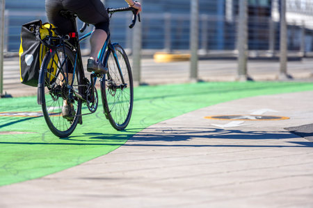 Woman rides a bike on a bike path. The use of a bicycle as the main transport for many enthusiasts...