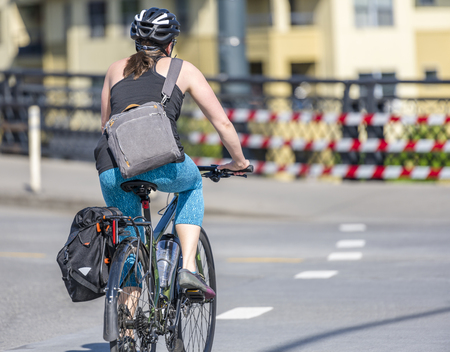 A woman who prefers to ride a bike is worthy of respect, it strengthens health, stimulates muscles, maintains elasticity and shape which is facilitated by cycling reducing weight and improving moodの写真素材