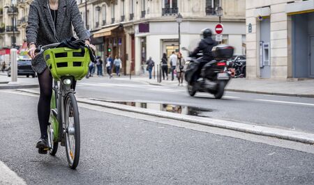 Riding a bike is not only useful but also beautiful. Cycling combines the elegance of movements emphasizing the advantages of a female figure dressed in a tight fit and effect of a slim elastic bodyの写真素材