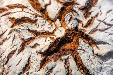 Natural organic tasty and healthy bread made of dark rye flour with cracked crispy crust after...