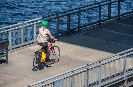 Woman rides a bike on a bike path. The use of a bicycle as the main transport for many enthusiasts...